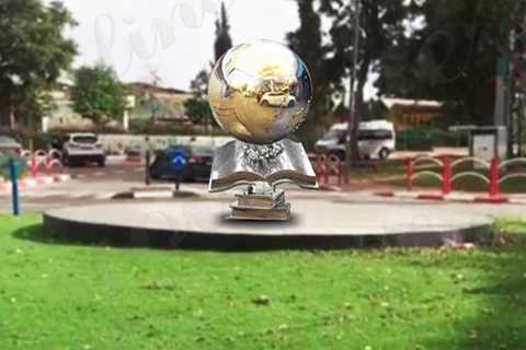 stainless steel ball and books sculptures