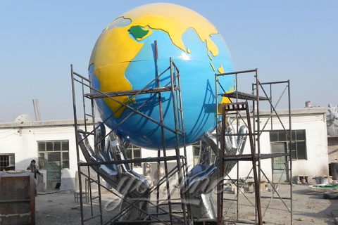 Outdoor Abstract Two hands hold the Earth sculpture in stainless steel